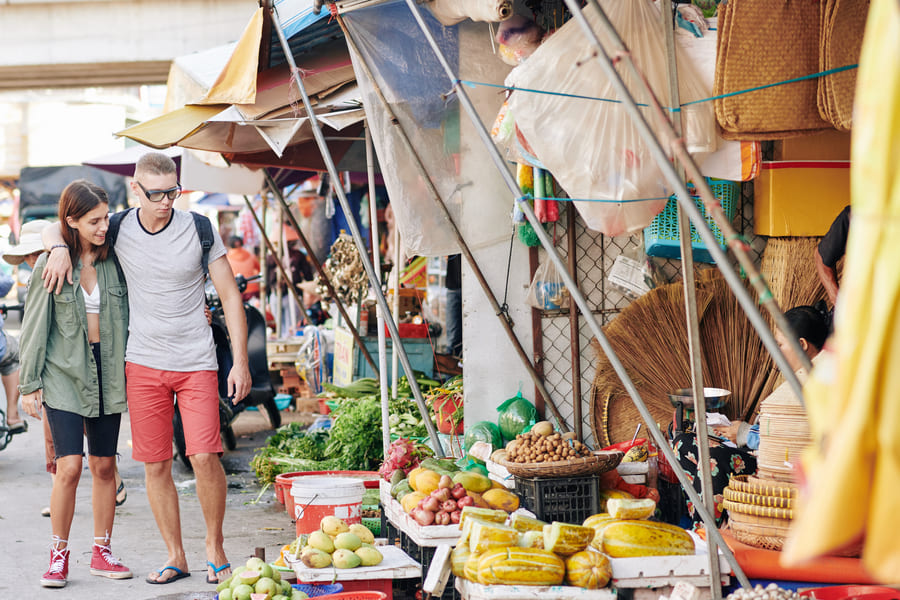 Dos turistas mujer y hombre caminando en el mercado chino - Destino China